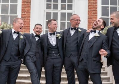 groom-and-bestman-laughing-together-at-stoke-place