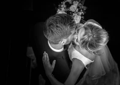 black and white couple holding and kissing portrait