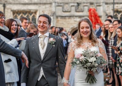 bride-and-groom-walking-through-a-confetti-line-at-church