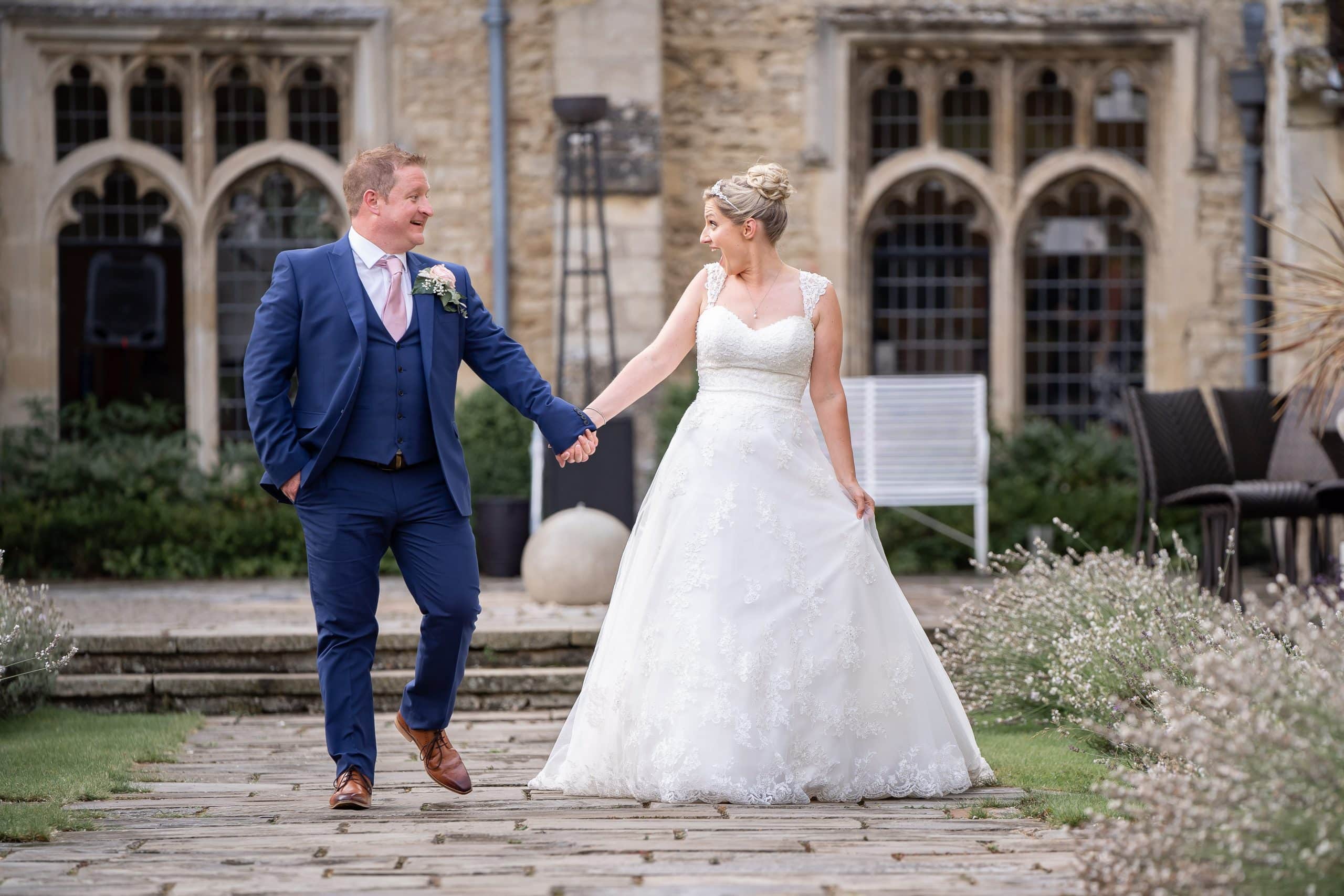 bride-and-groom-walking-holding-hands-in-notley-abbey-aylesbury