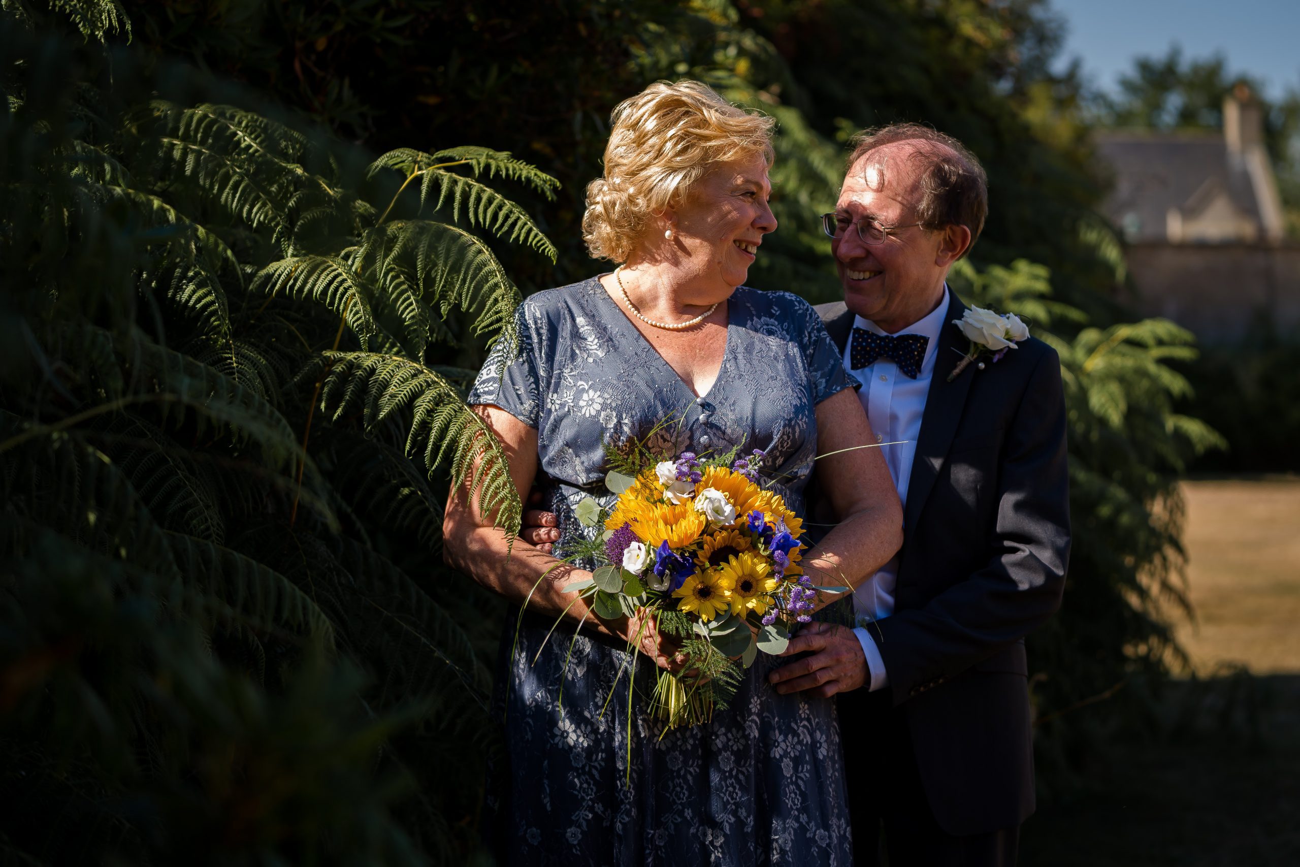 bridal-couple-embracing-in-gardens-at-shendish-manor-