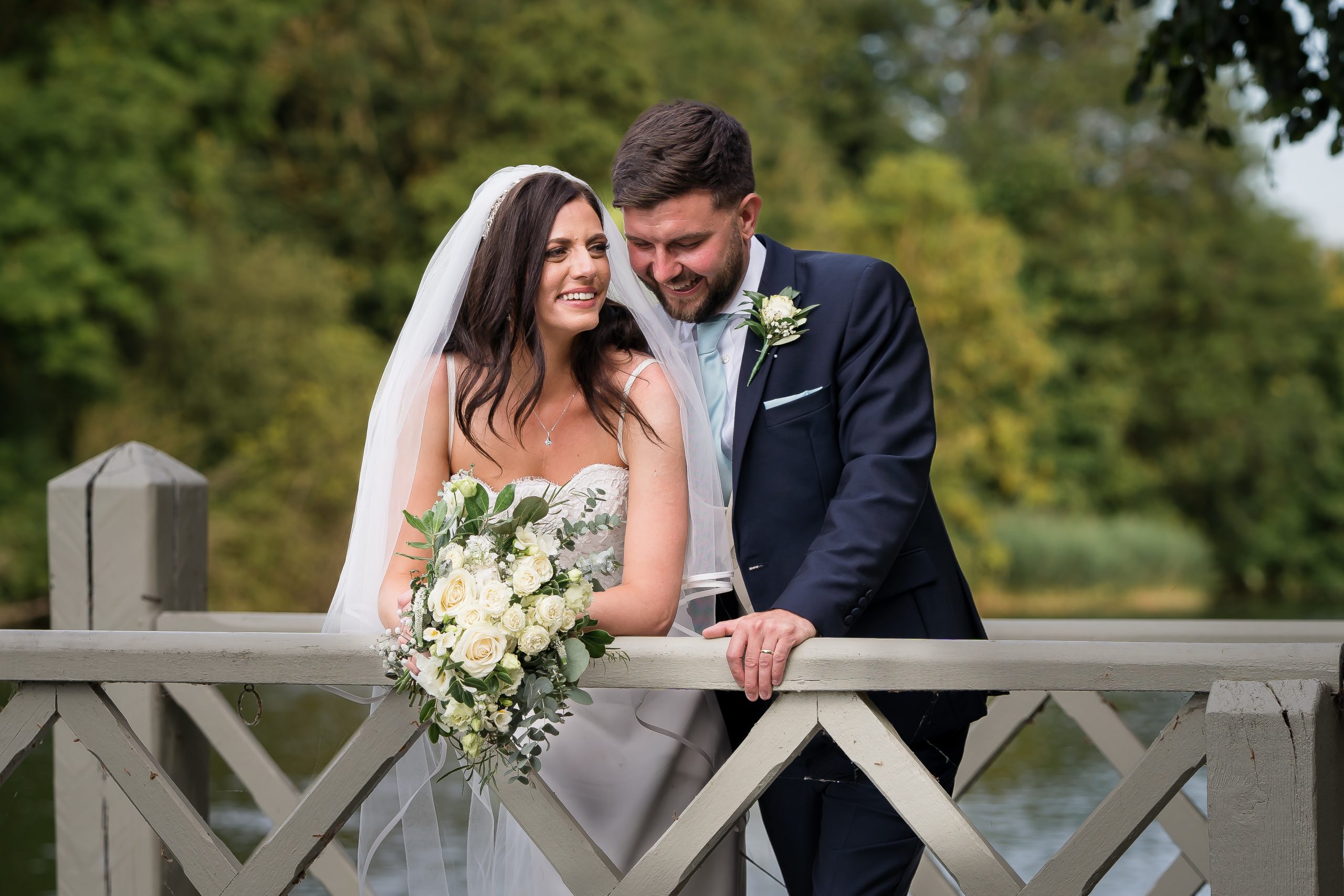 bridal-couple-leaning-over-getty-at-oakley-court-surrey